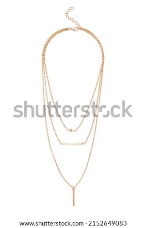 Close-up shot of a gold necklace. The necklace consists of three different chains and features a lobster clasp. The necklace is isolated on a white background. Front view. Royalty-Free Stock Photo #2152649083