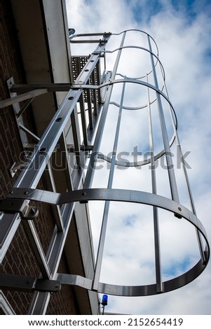 Industrial safety ladder or cage ladder of aluminium, to enter the roof. Royalty-Free Stock Photo #2152654419