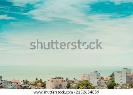 Beautiful panorama seaside town view real natural landscape frame photo background. Rooftops. Sea merges horizon skyline clouds. Calm peaceful life romance. Blue white bright more stock