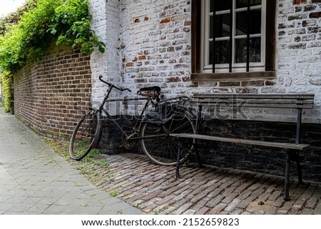 Mood pictures of ambiance in the small town oud-rekem.  Old bike and a little bench to take a break.  Toerism in the Limburg.  Promotional picture for biking in belgium flanders, mood picture