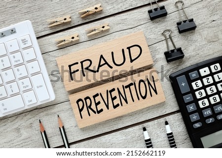 Fraud prevention . text on wooden blocks on wooden background