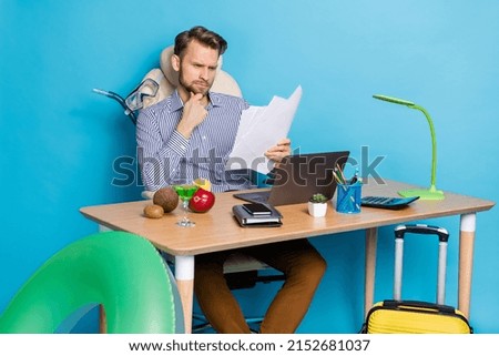 Photo of focused thoughtful businessman reading contract new project document make decision isolated on blue color background