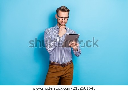 Photo of minded clever person hand chin read email brainstorming isolated on blue color background