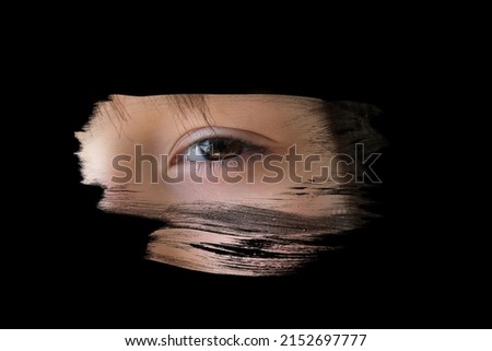 black mirror is painted over with strokes, Human eye is reflected, Young child 10-12 years old looking straight, concept of secrecy, Surveillance System, other world, mystery shrouded in darkness Royalty-Free Stock Photo #2152697777
