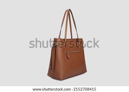 Side view on Brown Leather bag Handbag for women with long strap Hanging Isolated on White Background Royalty-Free Stock Photo #2152708415