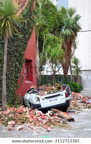 Earthquake - A Sedan car is crushed and  becomes a convertible during devastating Quake, Christchurch, New Zealand. Royalty-Free Stock Photo #2152713385