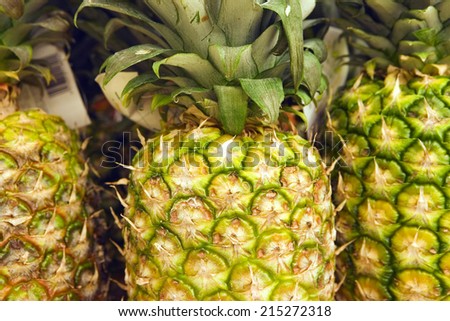 Selection of pineapples on display on market stall, close-up (full frame)
