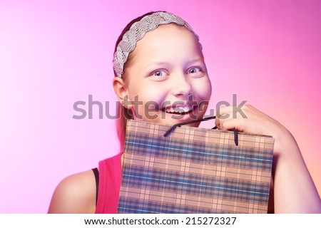 Beautiful happy teen girl receives a gift on a birthday