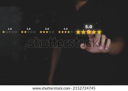 Customer review good rating concept hand pressing five star on visual screen and positive customer feedback testimonial. Royalty-Free Stock Photo #2152724745