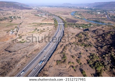 Aerial footage of the Mumbai-Pune Expressway near Pune India. The Expressway is officially called the Yashvantrao Chavan Expressway. Royalty-Free Stock Photo #2152727981