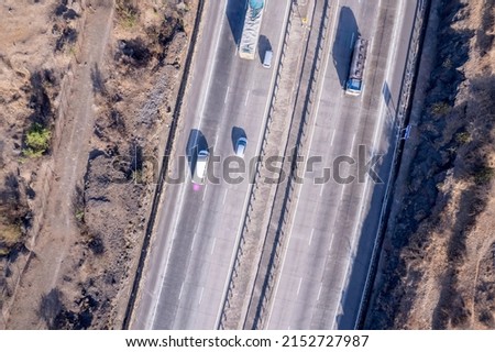 Aerial footage of the Mumbai-Pune Expressway near Pune India. The Expressway is officially called the Yashvantrao Chavan Expressway. Royalty-Free Stock Photo #2152727987