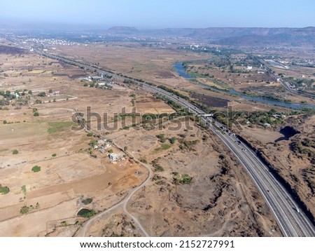 Aerial footage of the Mumbai-Pune Expressway near Pune India. The Expressway is officially called the Yashvantrao Chavan Expressway. Royalty-Free Stock Photo #2152727991