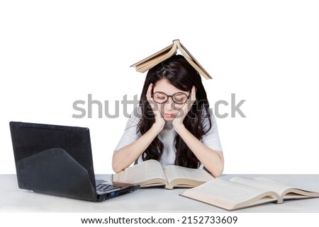 Asian female student looks bored while reading books in the studio. Isolated on white background