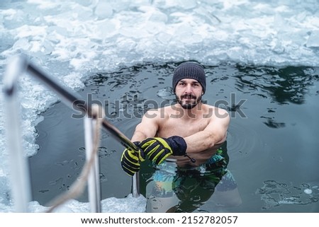 Winter swimming. Man in an ice-hole. Royalty-Free Stock Photo #2152782057
