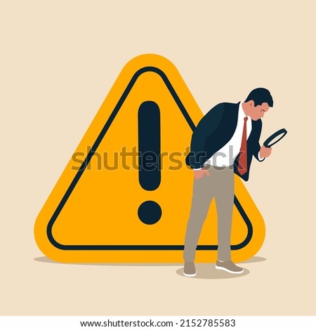 Businessman with magnifying monitor and investigate incident with exclamation attention sign. Incident management, root cause analysis or solving problem, identify risk or critical failure concept. Royalty-Free Stock Photo #2152785583