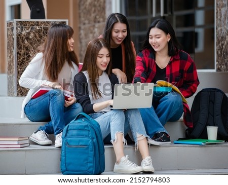 Group of four young attractive asian girls college students studying together using laptop in university campus outdoor. Concept for education, friendship and college students life. Royalty-Free Stock Photo #2152794803