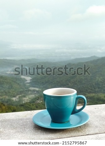 Cup of Coffee at Breakfast Table and Beautiful Landscape