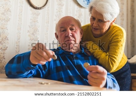 senior couple counting last cents medium shot living room money concept. High quality photo