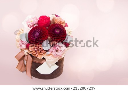 Bouquet of different flowers in decorative box on pink background. Beautiful template for design for greeting card to mothers day, Valentines Day, anniversary, birthday. Web banner With Copy Space