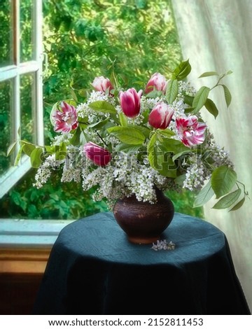 Still life with bouquet of spring flowers on open window background