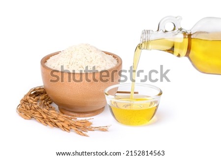 Rice bran oil extract with paddy and white rice on white background.  Royalty-Free Stock Photo #2152814563