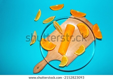 sweet dessert fruit ice cream with decorative slice orange and lemon on a plate and next to it, the glass plate is transparent, summer design