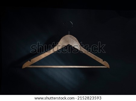 wooden hanger on a black background