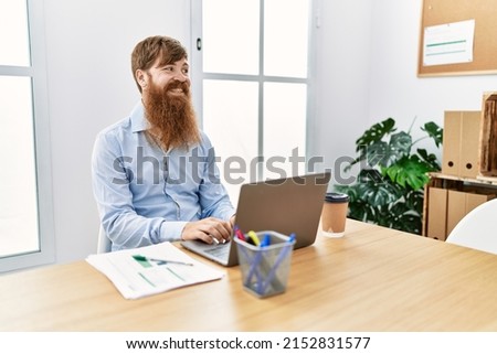 Young irish businessman smiling happy working at the office.