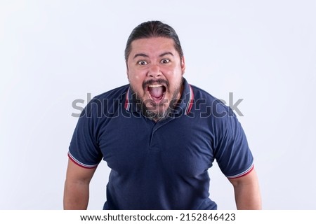 An enraged stocky man in his 30s screams in extreme rage. Showing threatening body language or shouting at someone. Royalty-Free Stock Photo #2152846423