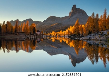 Fall sunrise on Lake Federa in the Italian Dolomites. Yellow larches create a unique atmosphere of this place. Royalty-Free Stock Photo #2152851701