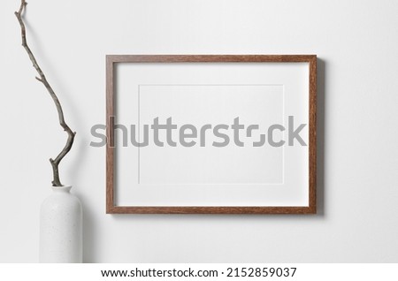 Horizontal frame mockup on white wall for artwork, photo, painting or print presentation