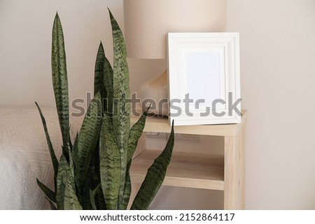 Wooden frames with empty space in the bedroom. Templates for decorating a room. Minimalist interior in rustic or boho style. Blank forms for your presentation