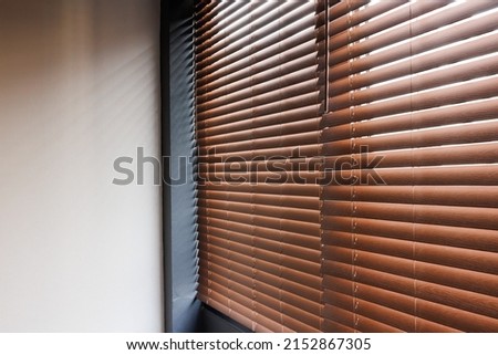 Wooden shutters blinds or windows blinds decorate in liveing room. Royalty-Free Stock Photo #2152867305