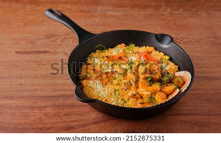 PERUVIAN FOOD: Rice with seafood. Arroz con Mariscos, food served in pan, Selective focus. Royalty-Free Stock Photo #2152875331