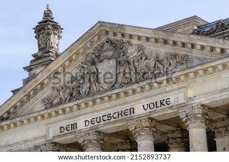 The Reichstag building (Bundestag) in Berlin, Germany, meeting place of the German parliament: The inscription says: Dem Deutschen Volke - To the German people Royalty-Free Stock Photo #2152893737
