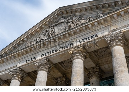 The Reichstag building (Bundestag) in Berlin, Germany, meeting place of the German parliament: The inscription says: Dem Deutschen Volke - To the German people Royalty-Free Stock Photo #2152893873