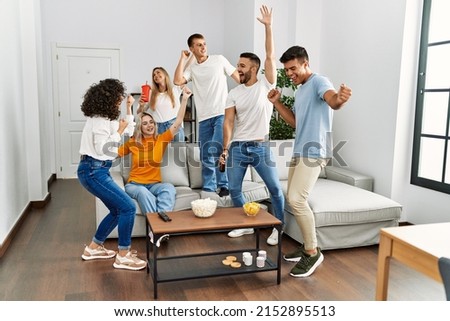 Group of young friends having party smiling happy and dancing at home.