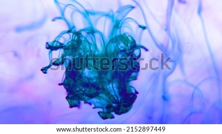 gorgeous image with multicolored ink in water, abstract vibrant multicolored different colors move slowly in water on white background.