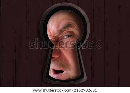 keyhole hole with Human eye, mature man 60 years old looking straight, covertly is following, drops of liquid, texture is dark, black, concept of secrecy, spying, Surveillance System, face Recognition Royalty-Free Stock Photo #2152902631