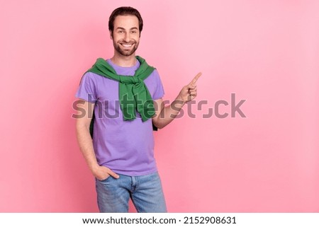 Photo of nice young beard man indicate promo wear purple t-shirt sweatshirt isolated on pink color background