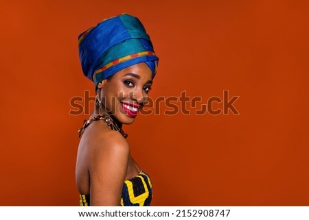 Photo of adorable cute woman wear ethnic turban smiling empty space isolated red color background