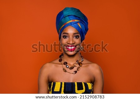 Photo of charming adorable woman wear ethnic turban accessories smiling isolated red color background