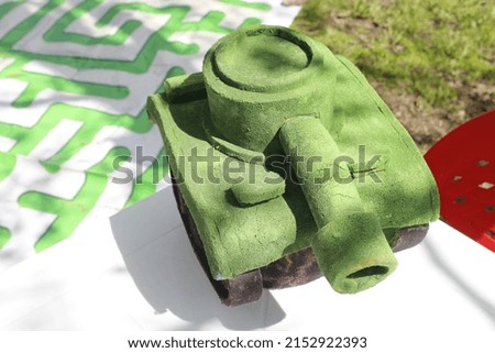 a green tank in miniature