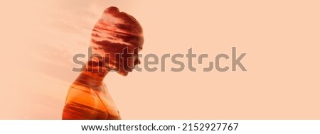 Conceptual image. Silhouette of young transparent woman and sunset landscape isolated over light peach background. Psychological matter. Double exposure effect. Concept of dreams, beauty Royalty-Free Stock Photo #2152927767