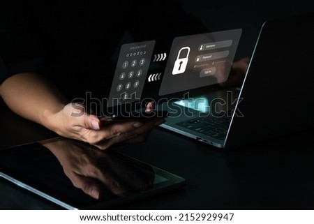 A woman with a mobile phone and a laptop computer has a safe account. Hacking a Phishing mobile phone with a password to get access to a smartphone, internet security issues. Royalty-Free Stock Photo #2152929947