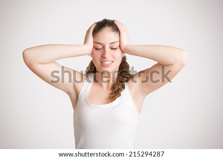 Woman suffering from an headache, holding her hand to the head