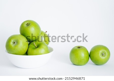 bowl with green and fresh apples on white
