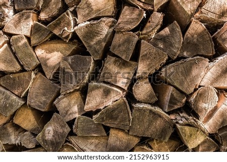 Natural firewood background. Quarters of firewood are put in a pile, prepared for winter, fire, saun. High quality photo
