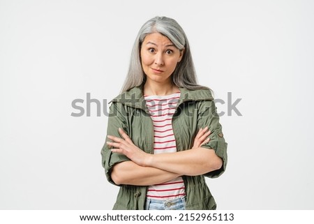 Offended caucasian middle-aged mature woman in casual clothes blowing her lips with arms crossed isolated in white background. Angry wife Royalty-Free Stock Photo #2152965113