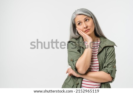 Sad bored tired caucasian mature middle-aged woman in casual clothes feeling exhausted offended in bad mood isolated in white background. Toothache Royalty-Free Stock Photo #2152965119